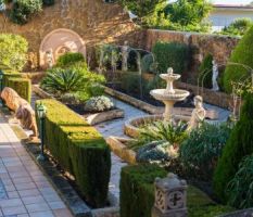 Fountain And Beautiful Sculptures In The Courtyard